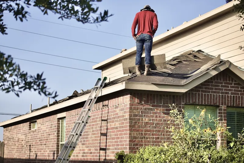 Professional roofer working on a residential roof in Spanaway